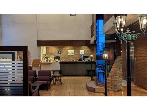 a lobby with a bar in a restaurant with purple chairs at KITA HOTEL - Vacation STAY 69754v in Morioka