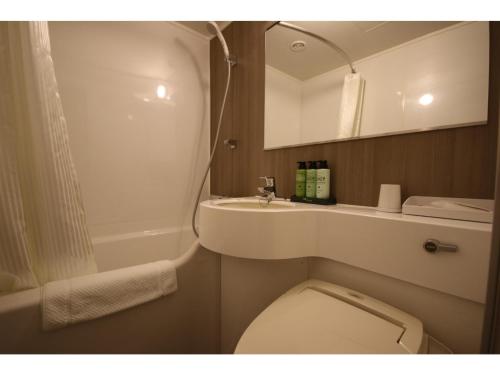 a bathroom with a toilet and a sink and a mirror at KITA HOTEL - Vacation STAY 69754v in Morioka