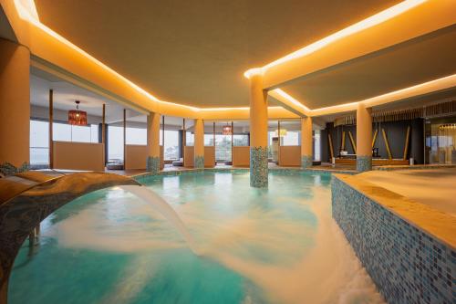 a swimming pool in the middle of a hotel at Trypiti Resort Blue Dream Palace and Hive Water Park in Limenaria