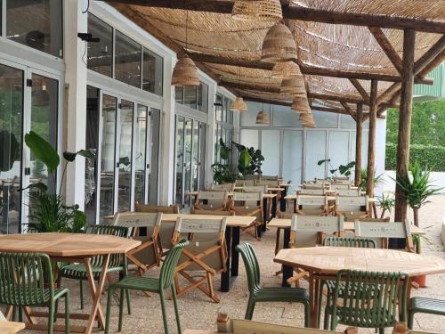 an empty restaurant with tables and chairs and windows at Praia_da_Rocha_Vista_Mar/Ocean_View in Portimão