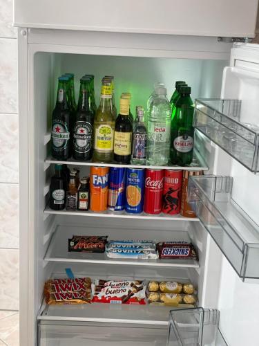 an open refrigerator filled with lots of drinks and food at Pougarka Apartments in Jajce