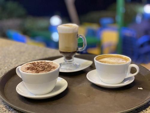two cups of coffee sitting on a tray at Kato Waidi Nubian Resort in Aswan