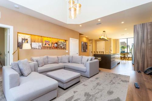 a living room with a couch and a table at Modern and Luxury 4 suites Villa near Disney 7521 in Orlando