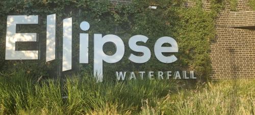 a sign that reads fire hose water fall at The Executive Apartment in Ellipse Waterfall City in Midrand