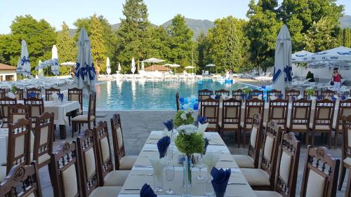 a table set up for a wedding in front of a pool at SPA Hotel Medicus in Varshets