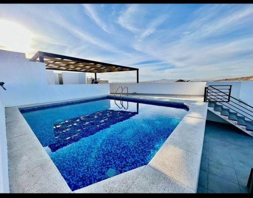a swimming pool in the middle of a house at Oceanview Condo / Rooftop pool in Cabo San Lucas