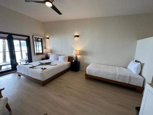 a hotel room with two beds and a window at Mt. Plaisir Estate Hotel in Grande Riviere