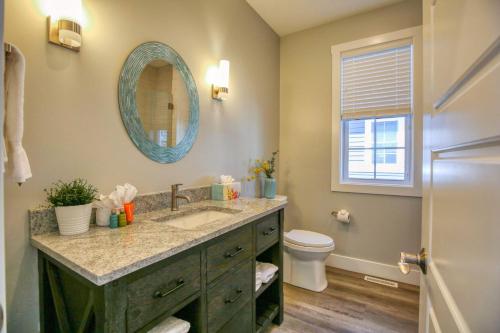 a bathroom with a sink and a toilet and a mirror at Aphrodite in Ottawa