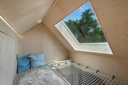a small room with a window and a bed at Bunkies- The Hold in Ottawa