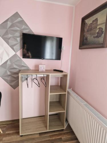 a tv on top of a table in a room at Stara Kuźnia Radków in Wünschelburg