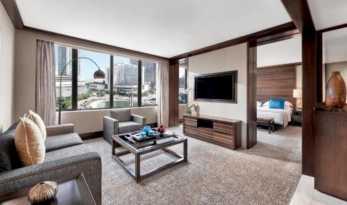 a living room with a couch and a tv at Mandarin Oriental, Jakarta in Jakarta