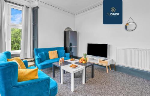 a living room with blue chairs and a table at THE DENS, 3 Rooms, 4 Beds, 2 Bathrooms, Fully Equipped, Wifi, Parking, Mid-Long Stays Rates Available by SUNRISE SHORT LETS in Dundee