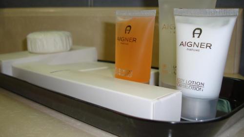 a counter with two bottles of hair products on it at Al Madina Suites Doha in Doha