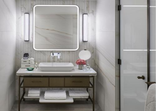 a bathroom with a sink and a mirror at Mandarin Oriental Palace, Luzern in Lucerne