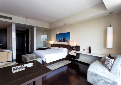 Hotel Ocean Inn Near Delhi Airport في نيودلهي: غرفة نوم بسرير وطاولة وكراسي