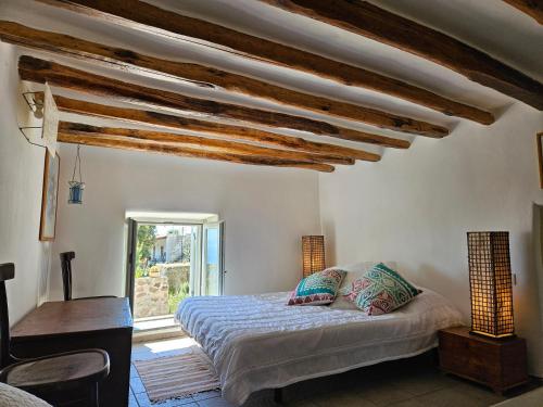 a bedroom with a bed and a window at Villa Margot in Lipari