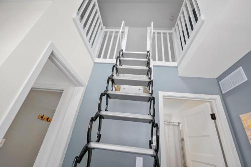 a spiral staircase in a room with blue walls at On Cloud Wine in Ottawa