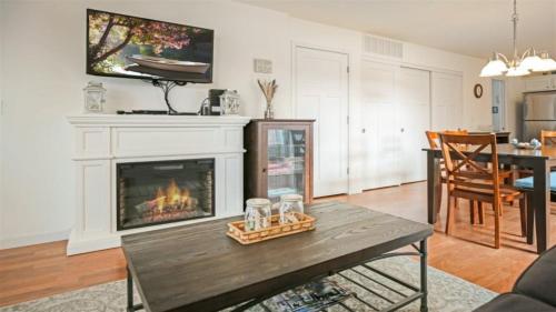 a living room with a fireplace and a table at Splash Haven in Ottawa