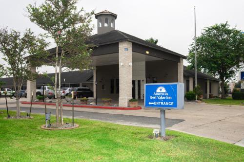 a building with a blue sign in front of it at Americas Best Value Inn Harlingen in Harlingen