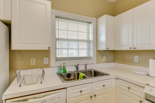 a kitchen with white cabinets and a sink at Charming Condo with Balcony, 1 Mi to UNC Charlotte! in Charlotte