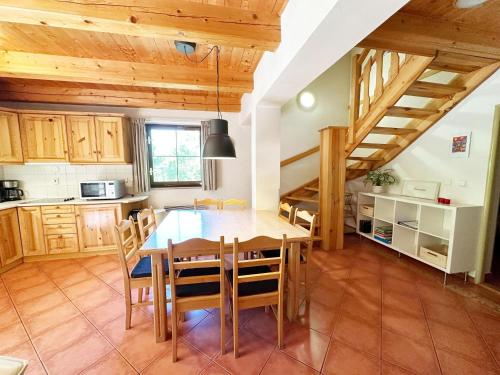 a kitchen and dining room with a table and chairs at Holiday Home in Rudn k with private garden in Rudník