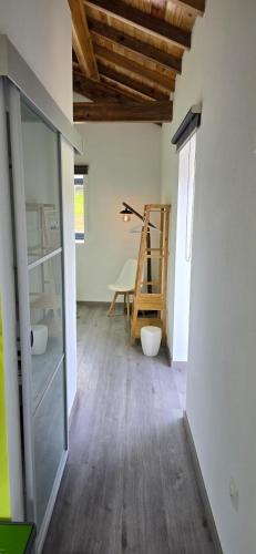 a room with a wooden floor and a ladder in it at Casa do Avô José Mota in Santa Cruz das Flores