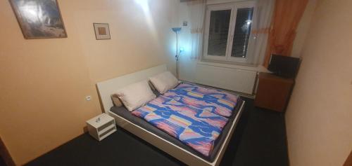 a small bedroom with a bed in a room at Lhotka Kopeček in Žďár nad Sázavou