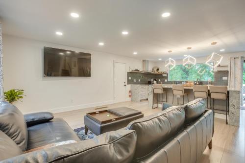 a living room with a couch and a kitchen at Spacious Riverfront Delaware Home with Views in Delaware