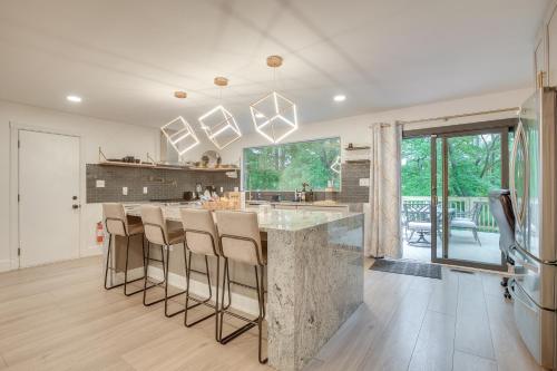 a kitchen with a large marble counter and bar stools at Spacious Riverfront Delaware Home with Views in Delaware