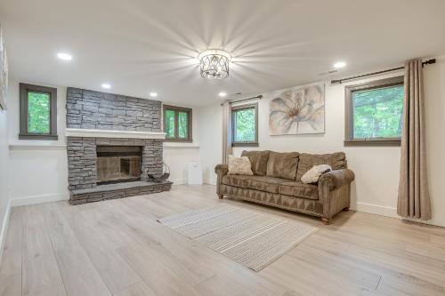 a living room with a couch and a fireplace at Spacious Riverfront Delaware Home with Views in Delaware