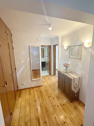 an empty living room with a table and a mirror at Lisbon Baixa 208 Apartment-Chiado in Lisbon