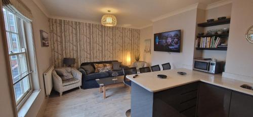 a kitchen and living room with a couch and a living room at Pear Apartment York City Centre - Self Check-in in York