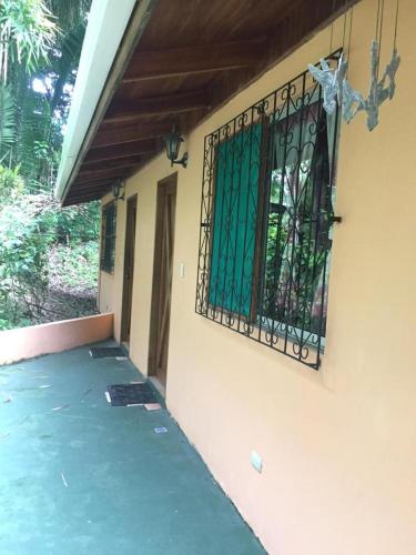 a iron gate on the side of a house at Mal Pais Surf Camp in Santa Teresa Beach