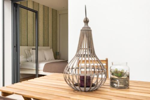 a dining table with a glass vase on top of it at Belem Design Apartments by Homing in Lisbon