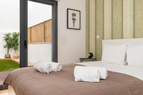 a bedroom with a large bed with towels on it at Belem Design Apartments by Homing in Lisbon