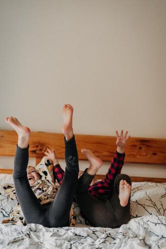 two people laying on a bed with their legs in the air at Chata u Cecila in Loučná nad Desnou