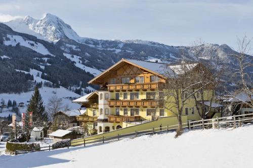 a large building on top of a snow covered mountain at Landhotel Untermüllnergut in Dorfgastein