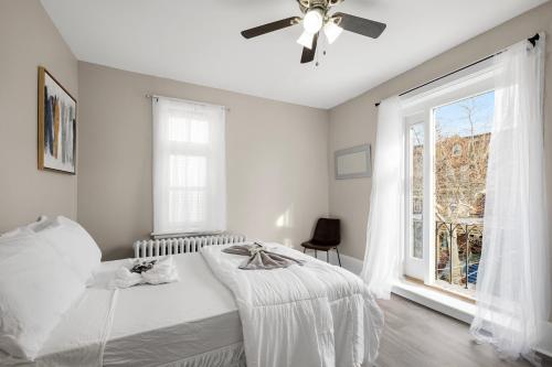 a white bedroom with a bed and a window at Univ City Upenndrexel 2 Bdrm Amazing Unit in Philadelphia