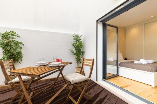 a room with a table and chairs and a bedroom at Belem Design Apartments by Homing in Lisbon
