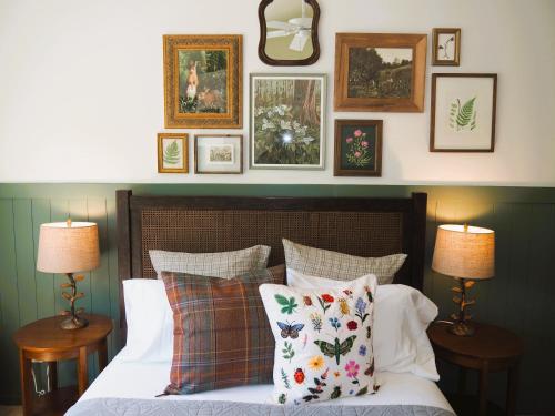 a bedroom with a bed with pillows and pictures on the wall at Sandhill House - Spectacular Lake Home With Toys! in Beulah