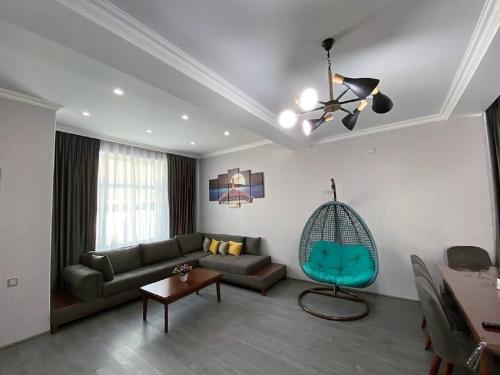 a living room with a couch and a chair at Qafqaz Resort Wonderland in Gabala