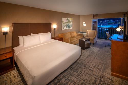 a bedroom with a large bed and a living room at Silver Cloud Hotel - Seattle Lake Union in Seattle