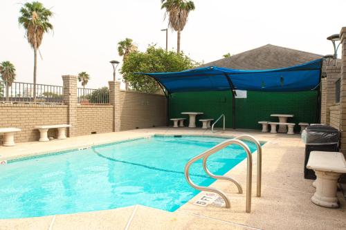 a large swimming pool with a blue cover over it at Americas Best Value Inn Harlingen in Harlingen