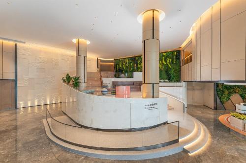 a lobby with a spiral staircase in a building at EVEN Hotel Yinchuan Yuehai by IHG in Yinchuan