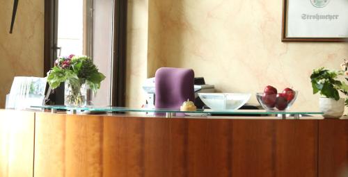 a counter top with a purple chair and flowers on it at Bürgermeisterkapelle in Hildesheim