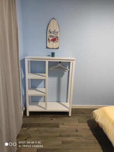 a white cabinet with a hat on top of it at Yellow Door in Gafanha da Encarnação