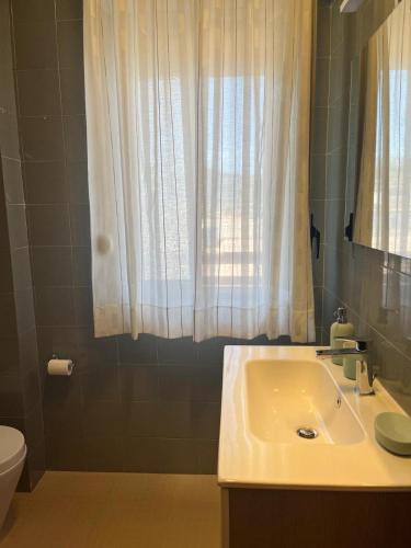 a bathroom with a sink and a toilet at Profumo di Mare 2 in Alcamo Marina