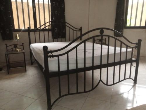 a black bed with a white mattress on it at BERGET ZACA in Ouagadougou