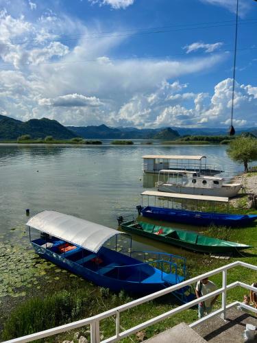 two boats are docked on the water on a lake at Lakeside Harmony Apartment in Golubovci