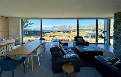 a living room with a couch and a table at Luxury Lakeview Apartment - Lake Tekapo in Lake Tekapo